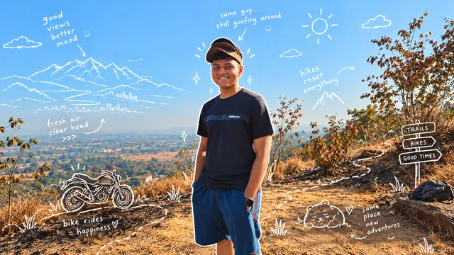 Smiling on a hillside beneath a blue sky, with doodles of mountains, a motorcycle and trails, and notes about fresh air, bike rides, hikes and new adventures.